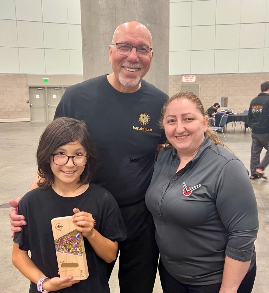 Ren S.M.receives the Nanka Judoka of the year award with Dan Augustine, and Kristina K of