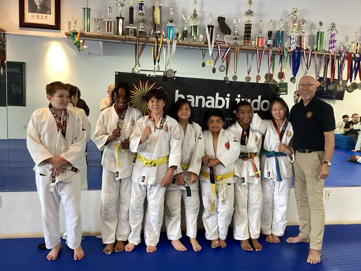Hanabi Judo group with banner — Hanabi Judo, Albany CA