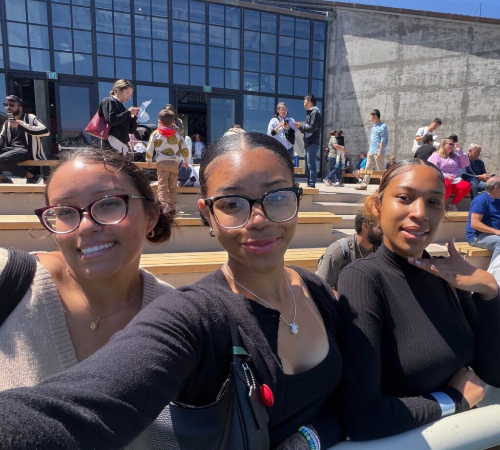LaJohnica, center, with college friends in front of the Monterey Aquarium.